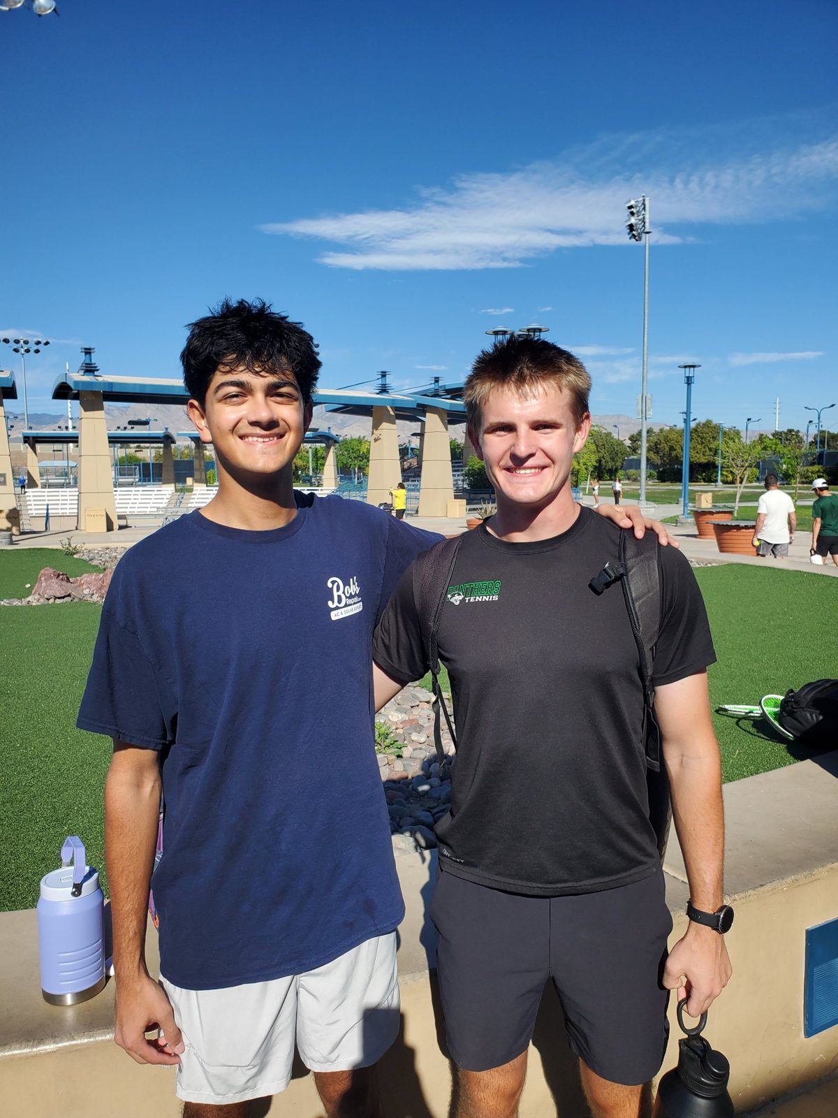 Joey and Muhammad smiling together at a tennis center in Las Vegas